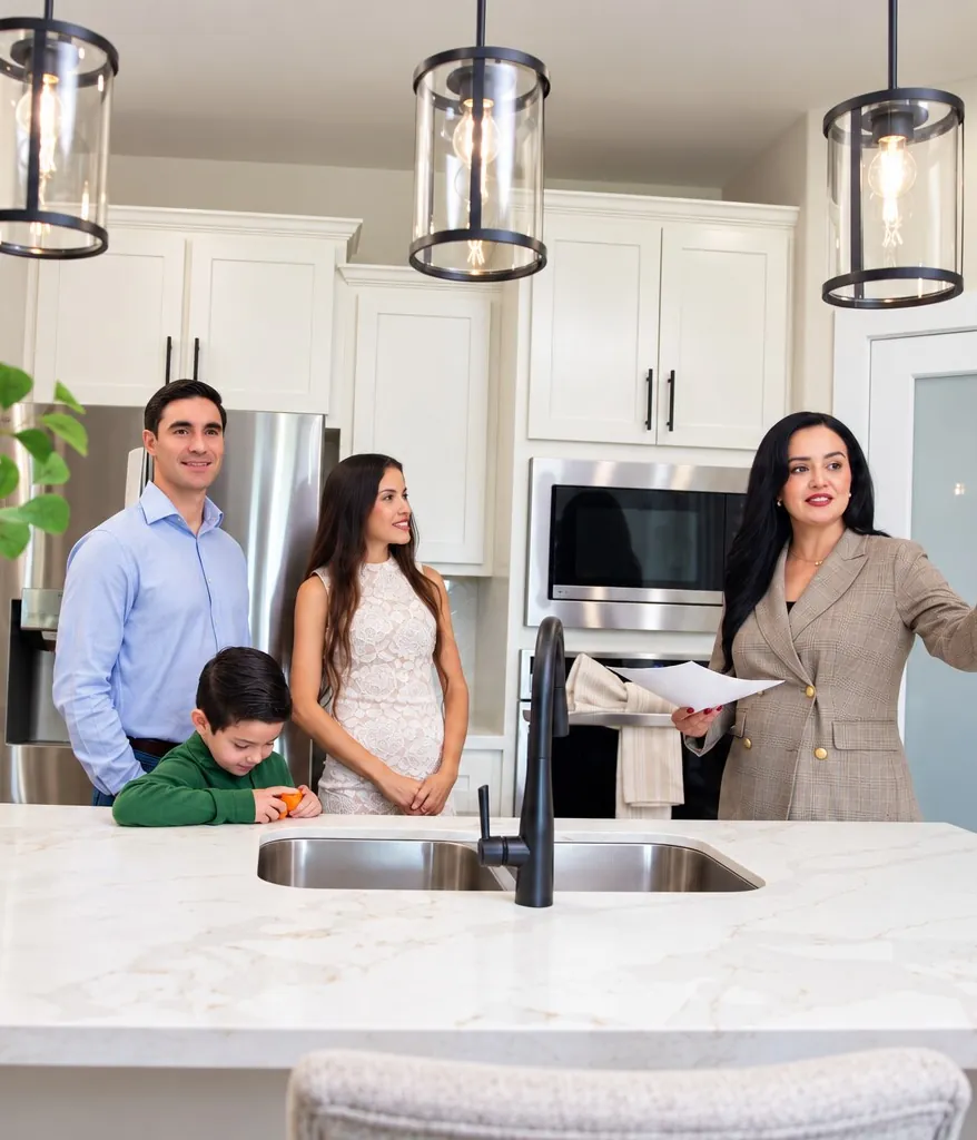 Home buyers touring a kitchen with their real estate agent before closing
